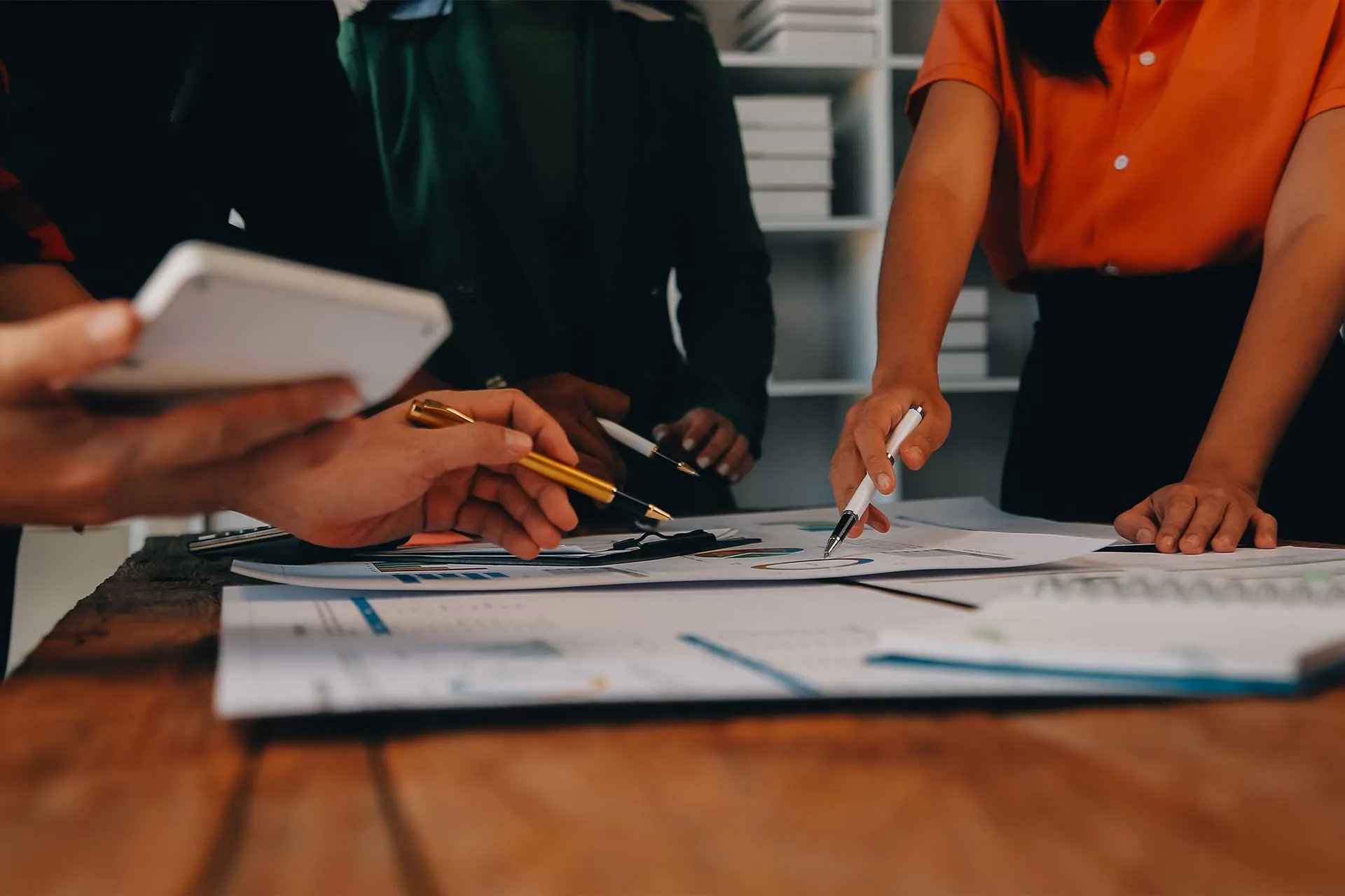 A nonprofit team collaborating around plans and working documents
